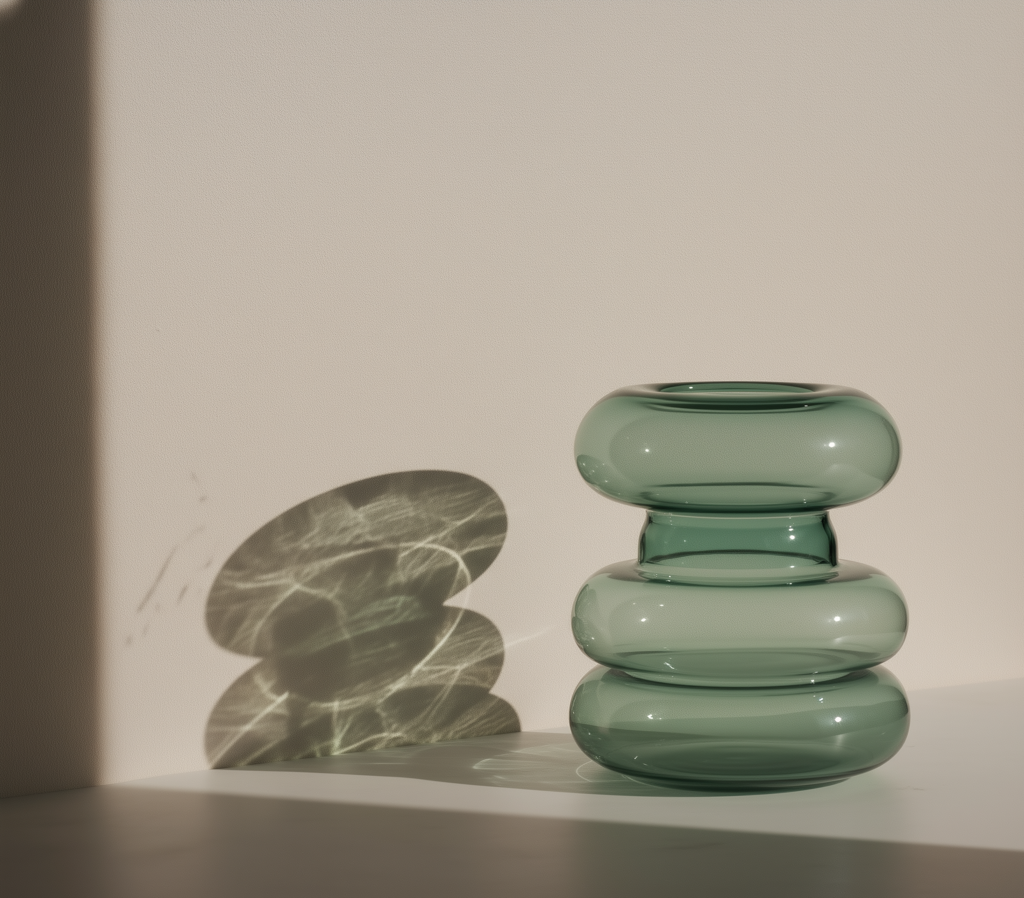 Mugen Shella Vase in teal handblown glass placed in a contemporary interior setting